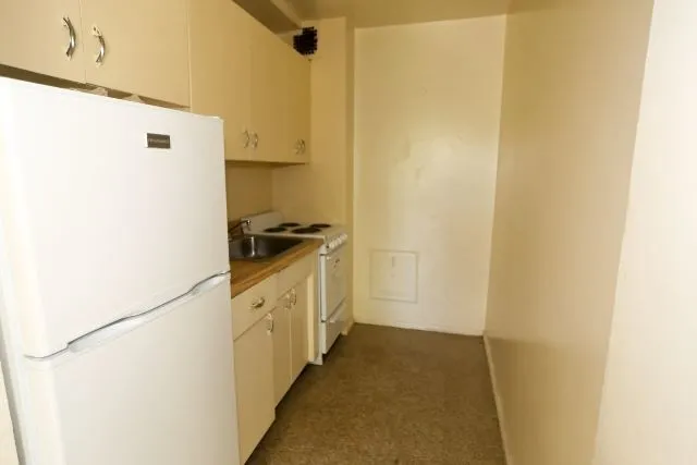 a kitchen with a refrigerator and a stove