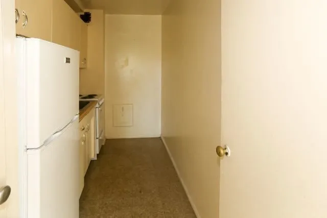 a view of a hallway with a white door