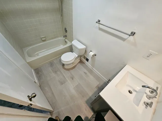 a bathroom with a sink a toilet and a bathtub