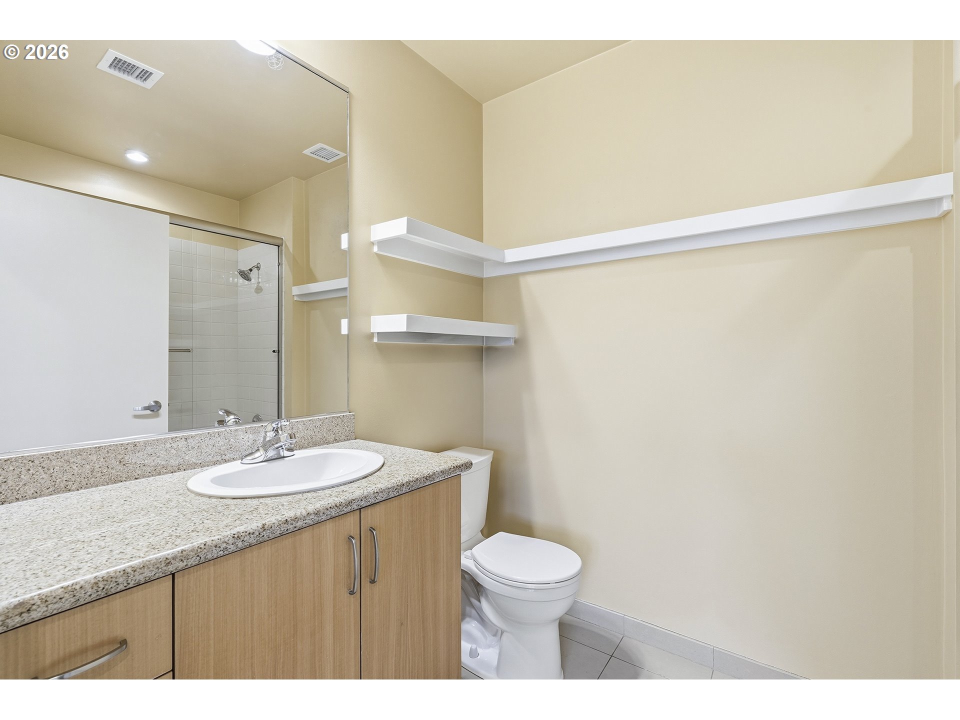 1930 Northwest Irving Street, Unit 302 Portland, OR 97209 - Photo 12 of 26 a bathroom with a granite countertop sink toilet and shower