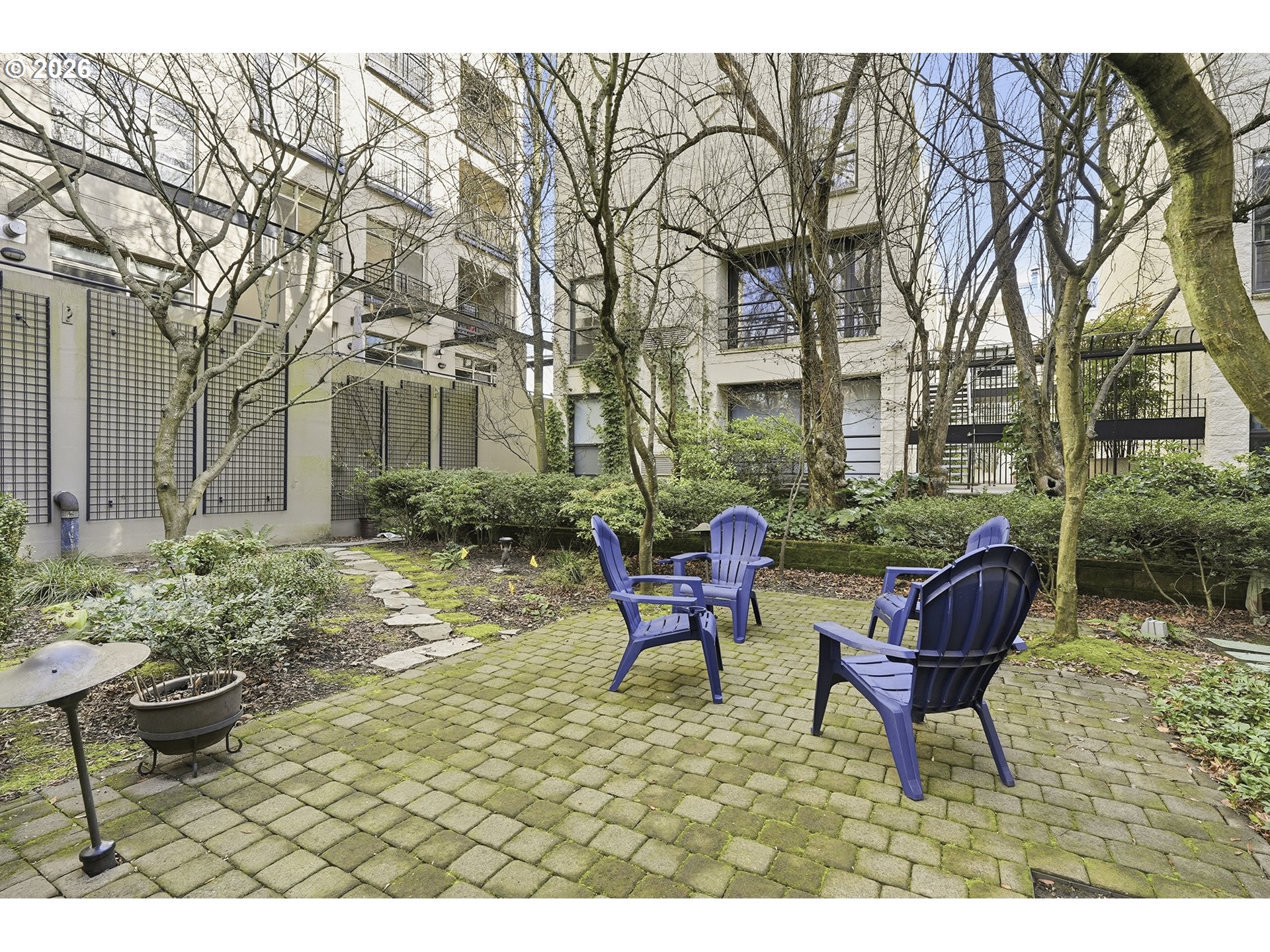 1930 Northwest Irving Street, Unit 302 Portland, OR 97209 - Photo 17 of 26 a backyard of a house with outdoor seating