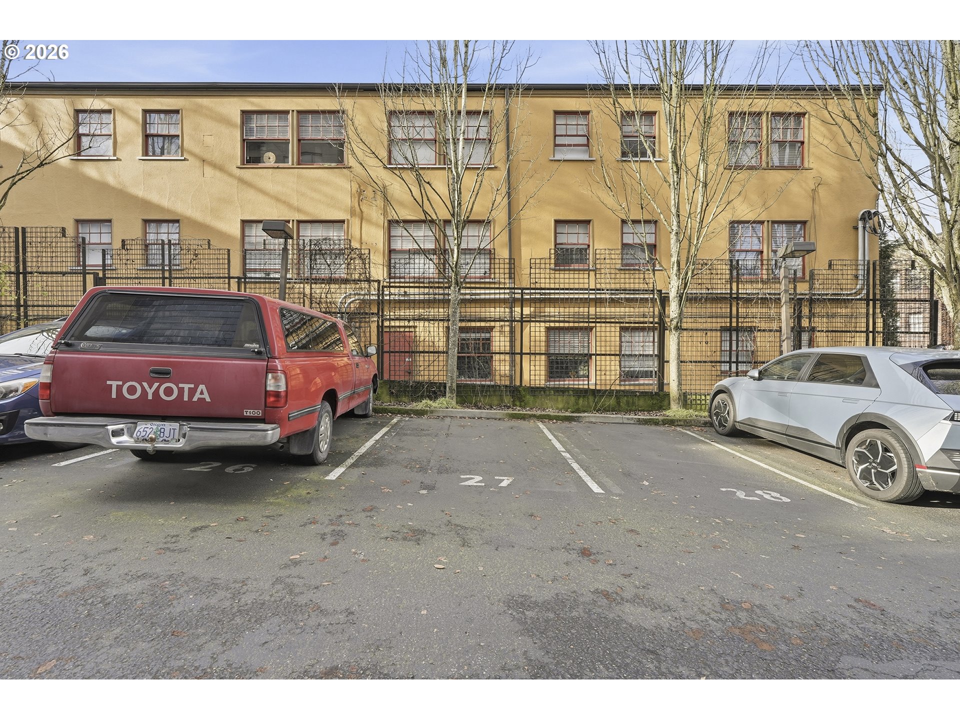 1930 Northwest Irving Street, Unit 302 Portland, OR 97209 - Photo 23 of 26 a front view of a house with parking space