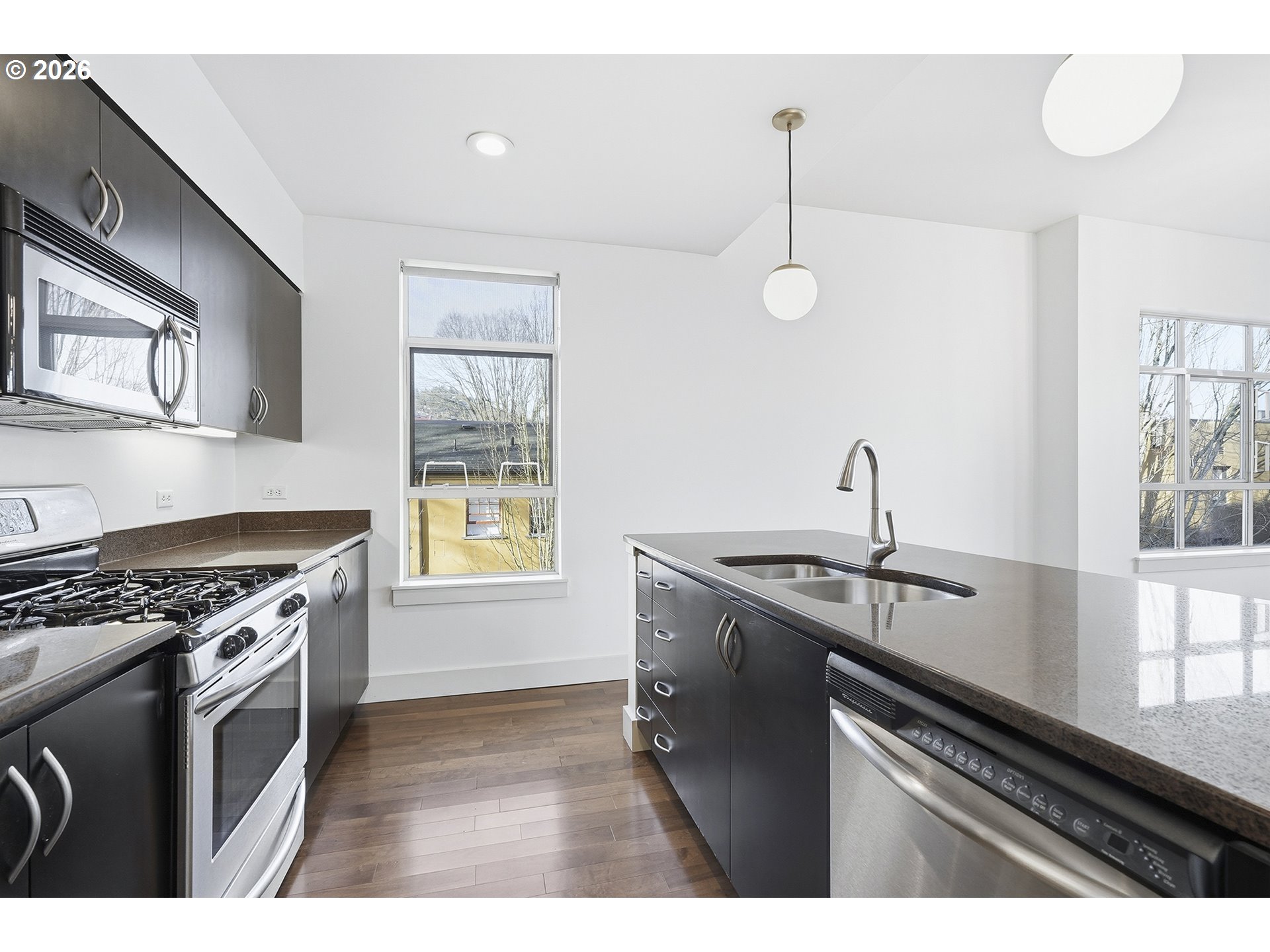 1930 Northwest Irving Street, Unit 302 Portland, OR 97209 - Photo 7 of 26 a kitchen with a stove and a sink