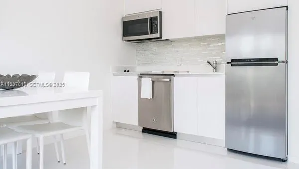 a view of a storage and utility room with washer and dryer