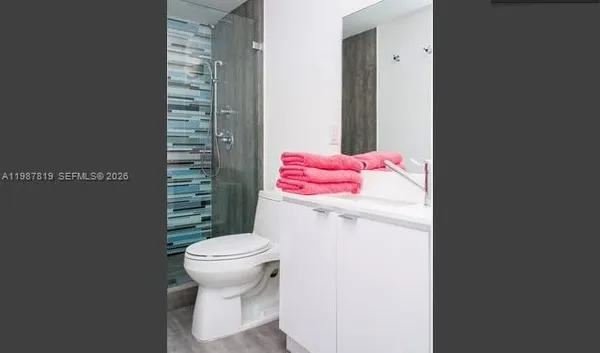 a bathroom with a toilet and a shower