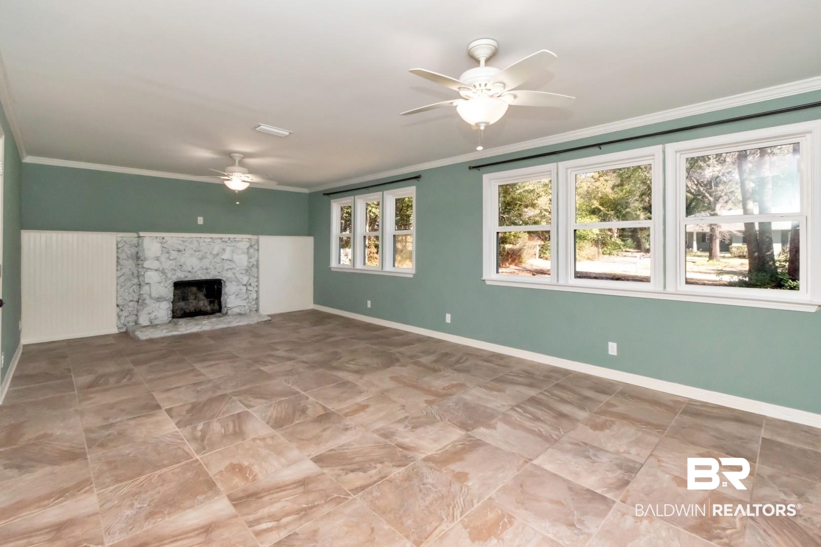 410 St John Place Mobile, AL 36609 - Photo 14 of 32 Unfurnished living room featuring ceiling fan, a fireplace, and crown molding