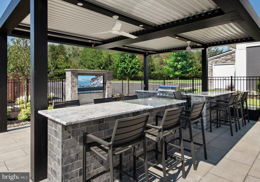 202 Gerry Way Ambler, PA 19002 - Photo 9 of 39 a view of a patio with table and chairs under an umbrella