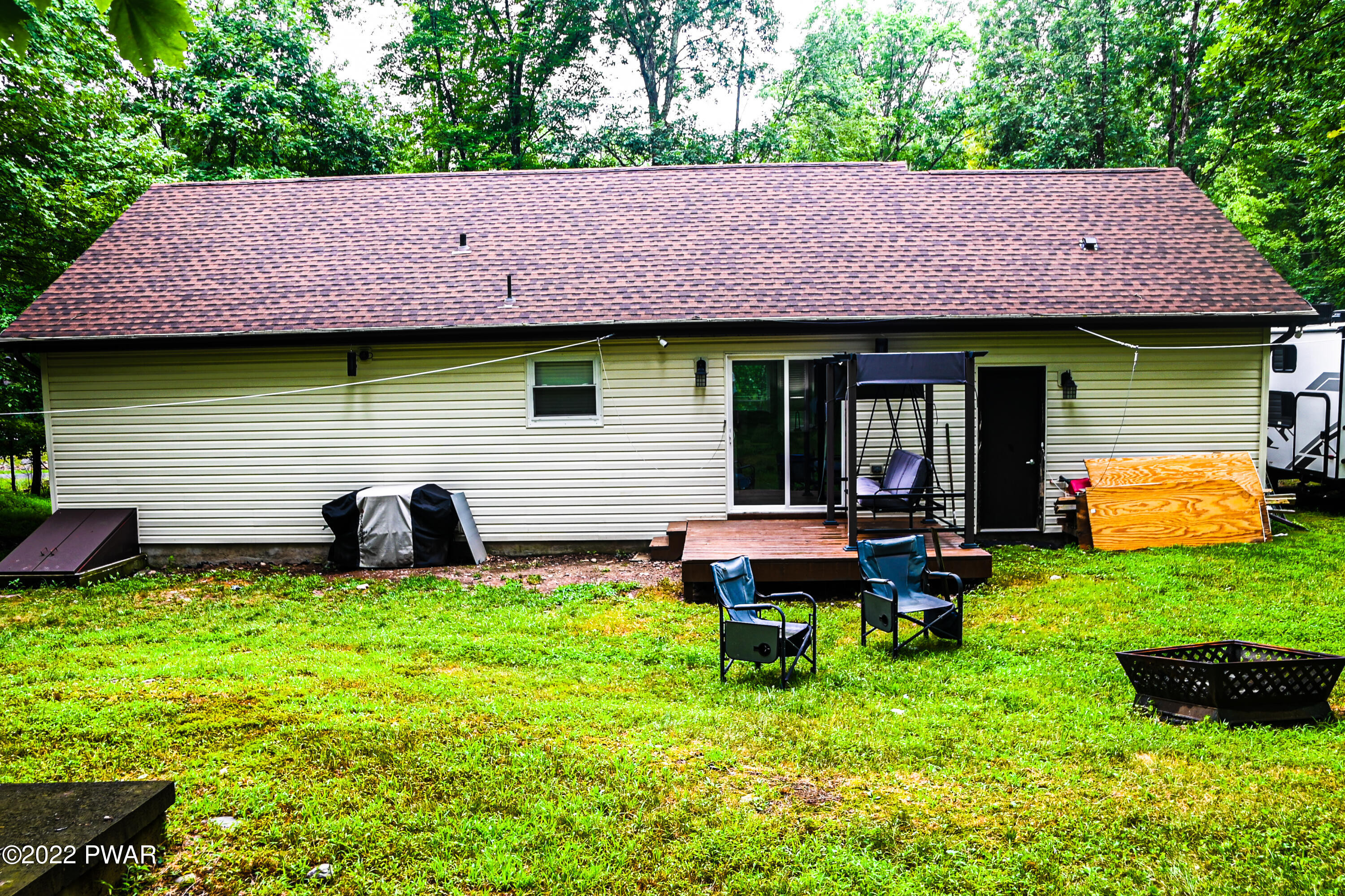 233 Bromley Road Henryville, PA 18332 - Photo 18 of 22 a backyard of a house with table and chairs