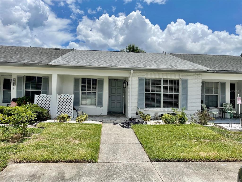 2852 Stillwell Court New Port Richey, FL 34655 - Photo 2 of 13 a front view of a house with garden and porch