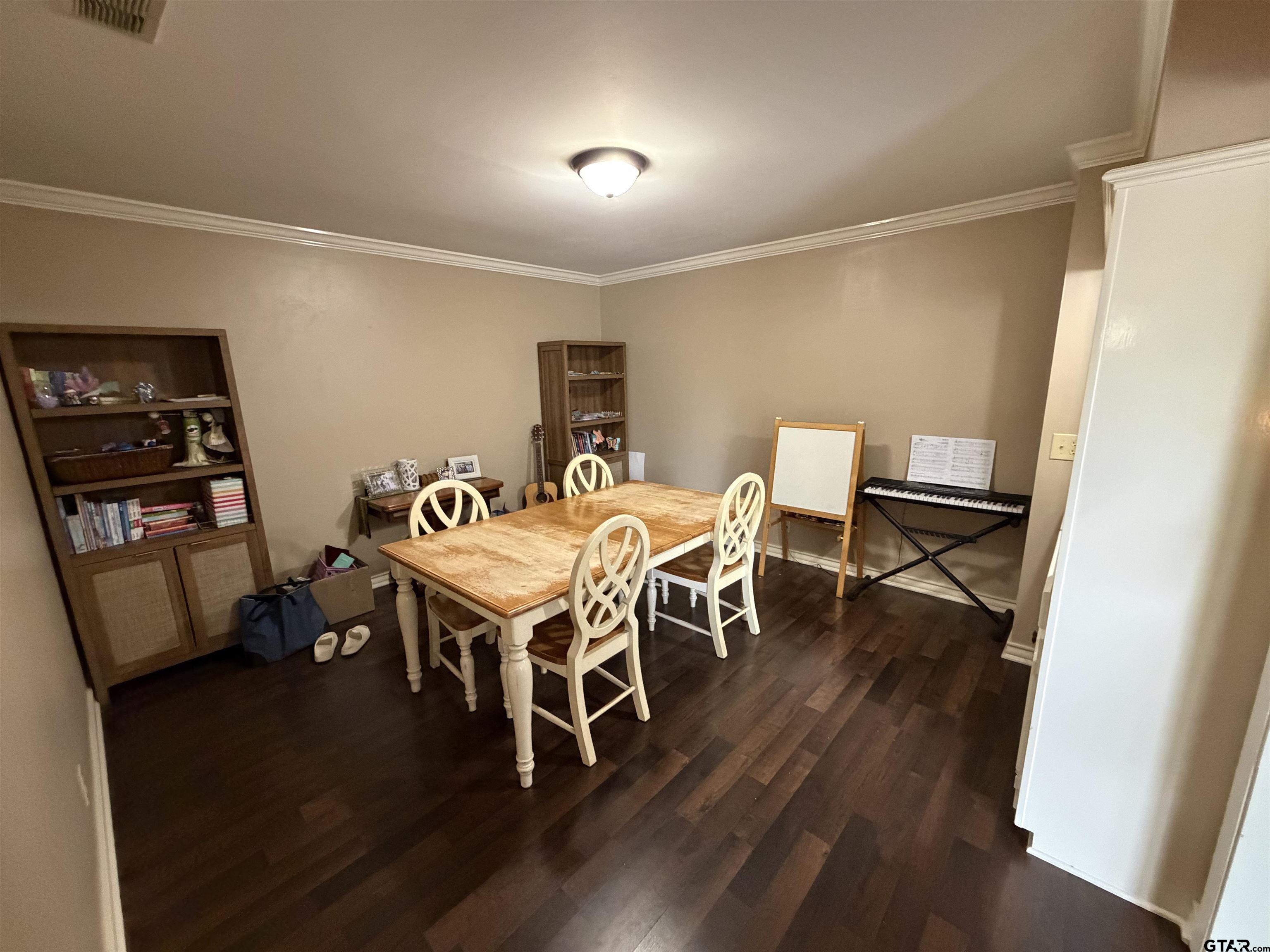 5704 Foxcroft Road Tyler, TX 75703 - Photo 4 of 10 a dining room with furniture and wooden floor