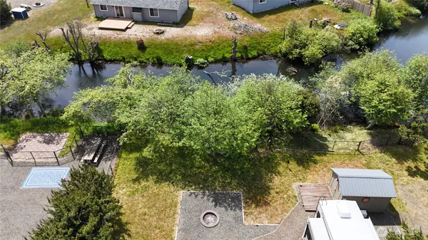 a backyard of a house with table and chairs