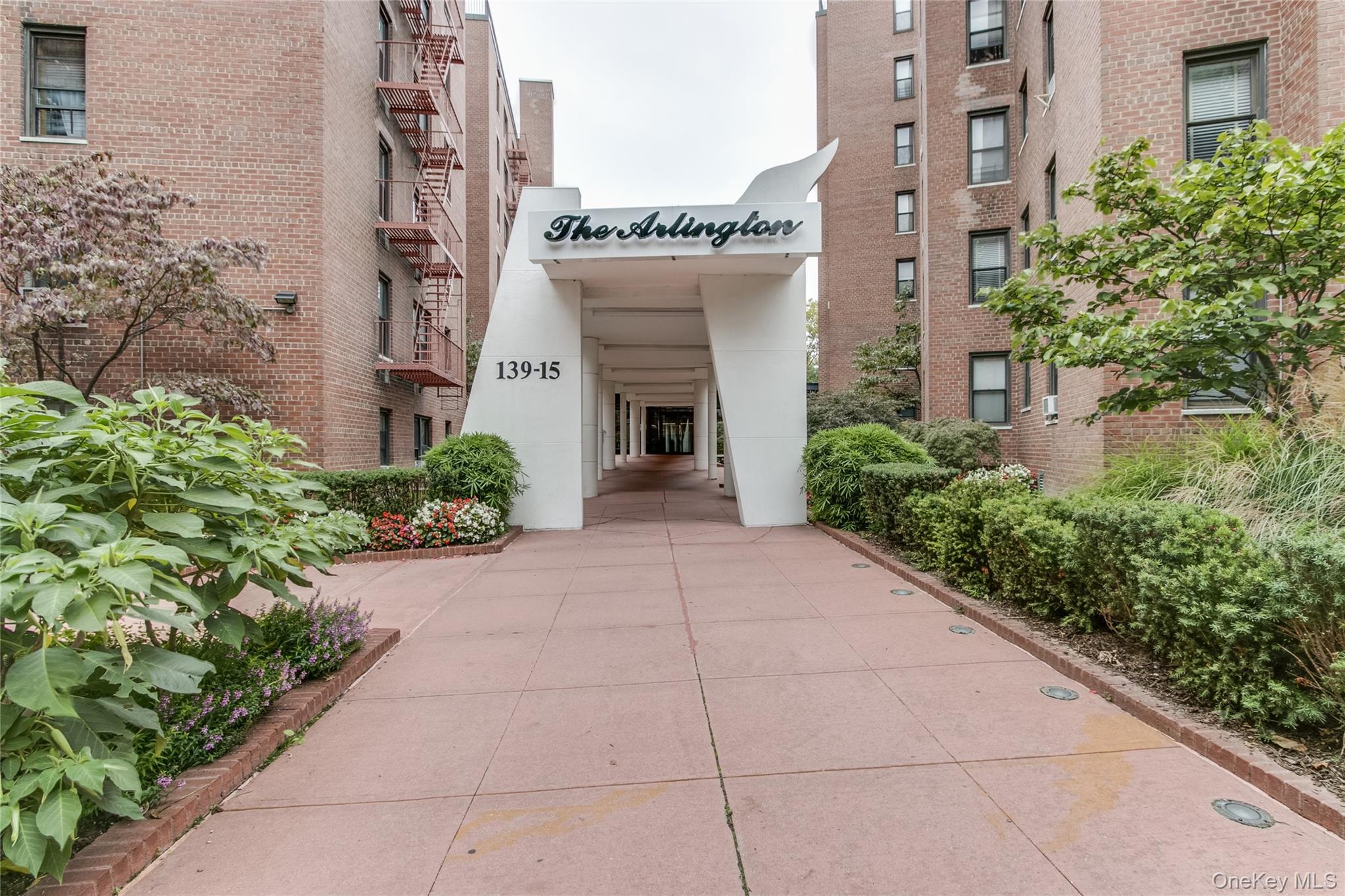 139-15 83rd Avenue, Unit 305 Queens, NY 11435 - Photo 1 of 21 a front view of a building with garden