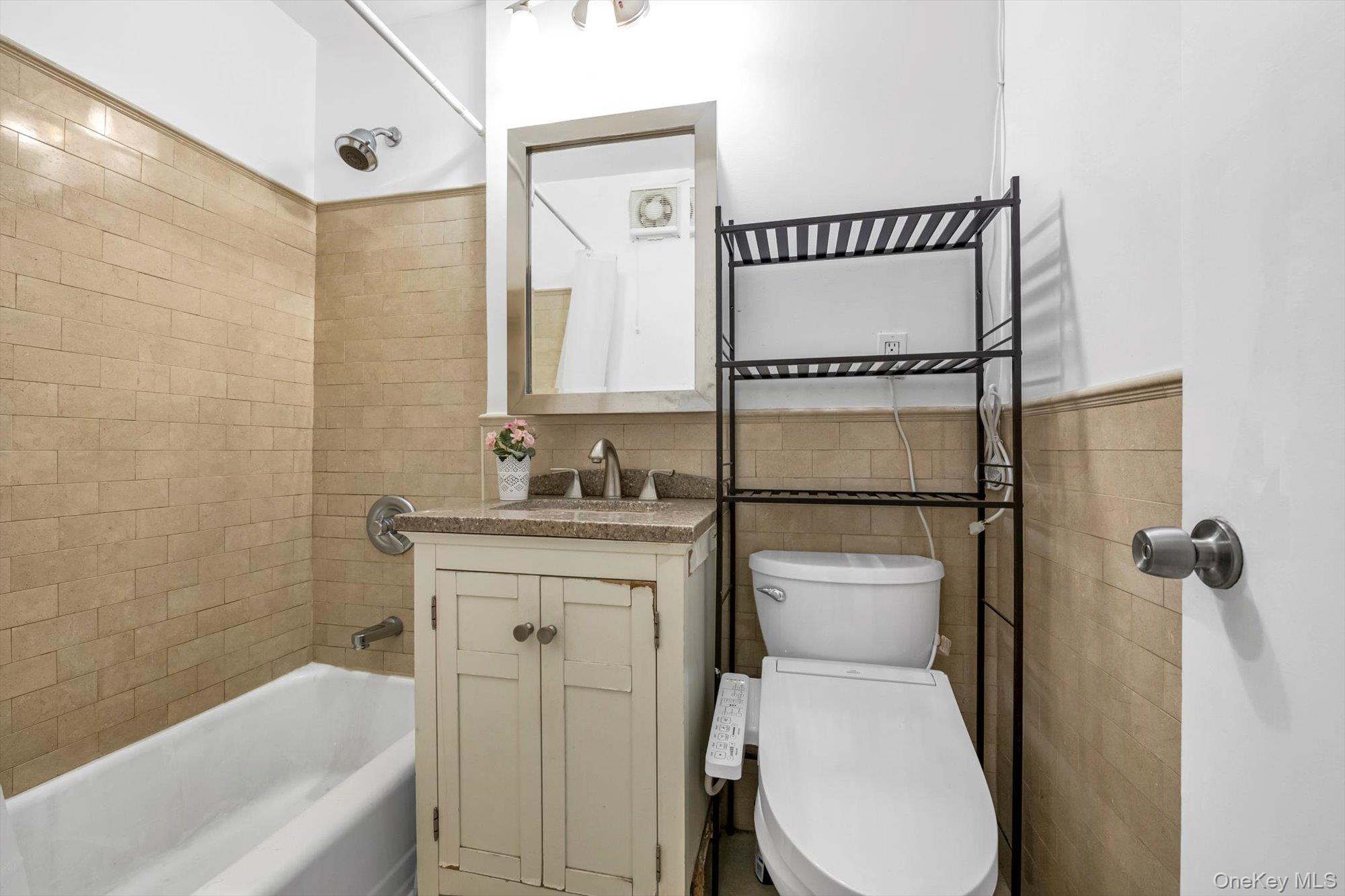 139-15 83rd Avenue, Unit 305 Queens, NY 11435 - Photo 17 of 21 a bathroom with a sink toilet and shower