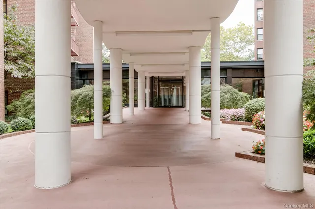 a view of a brick house with potted plants