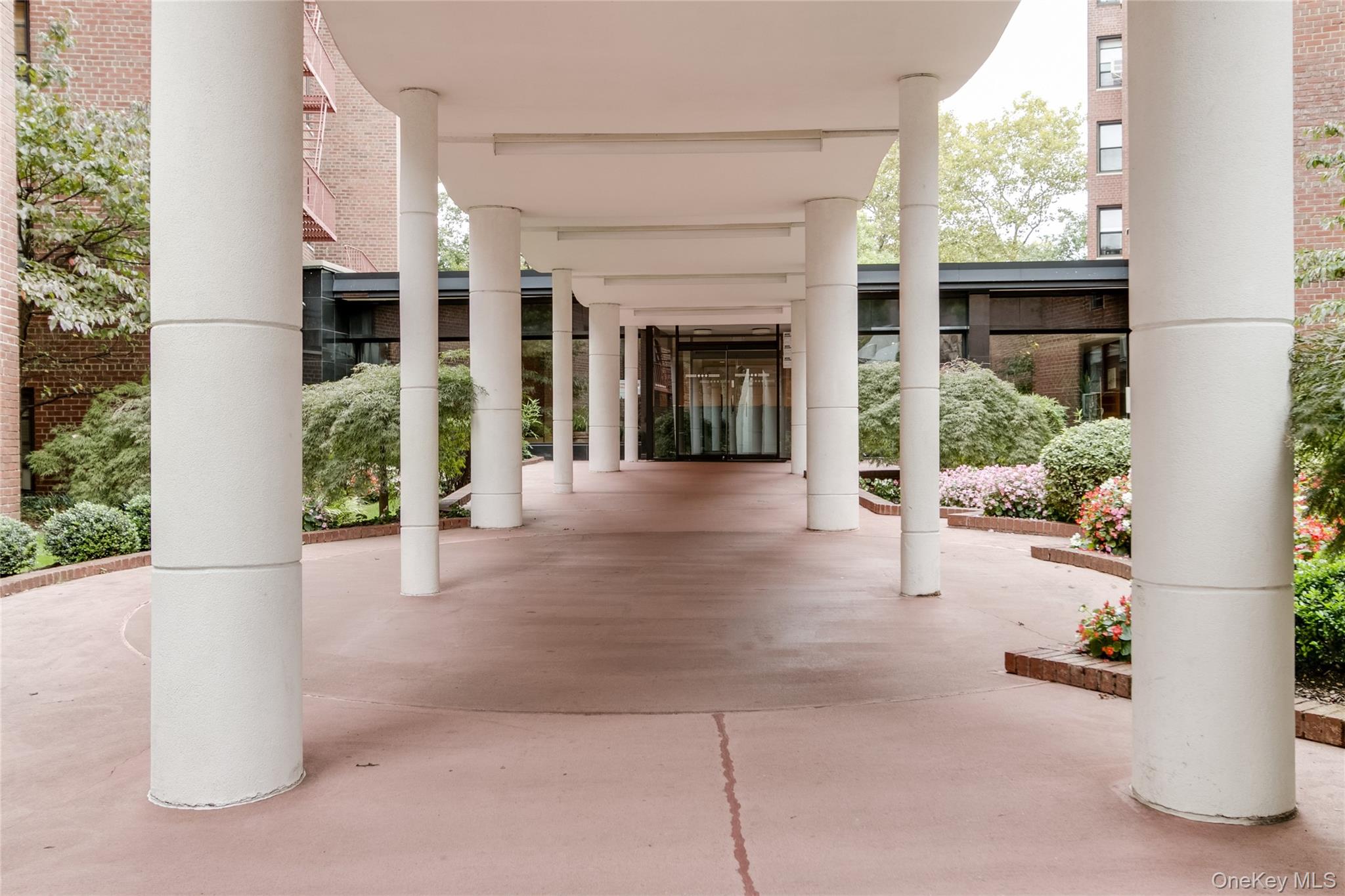 139-15 83rd Avenue, Unit 305 Queens, NY 11435 - Photo 4 of 21 a view of a brick house with potted plants