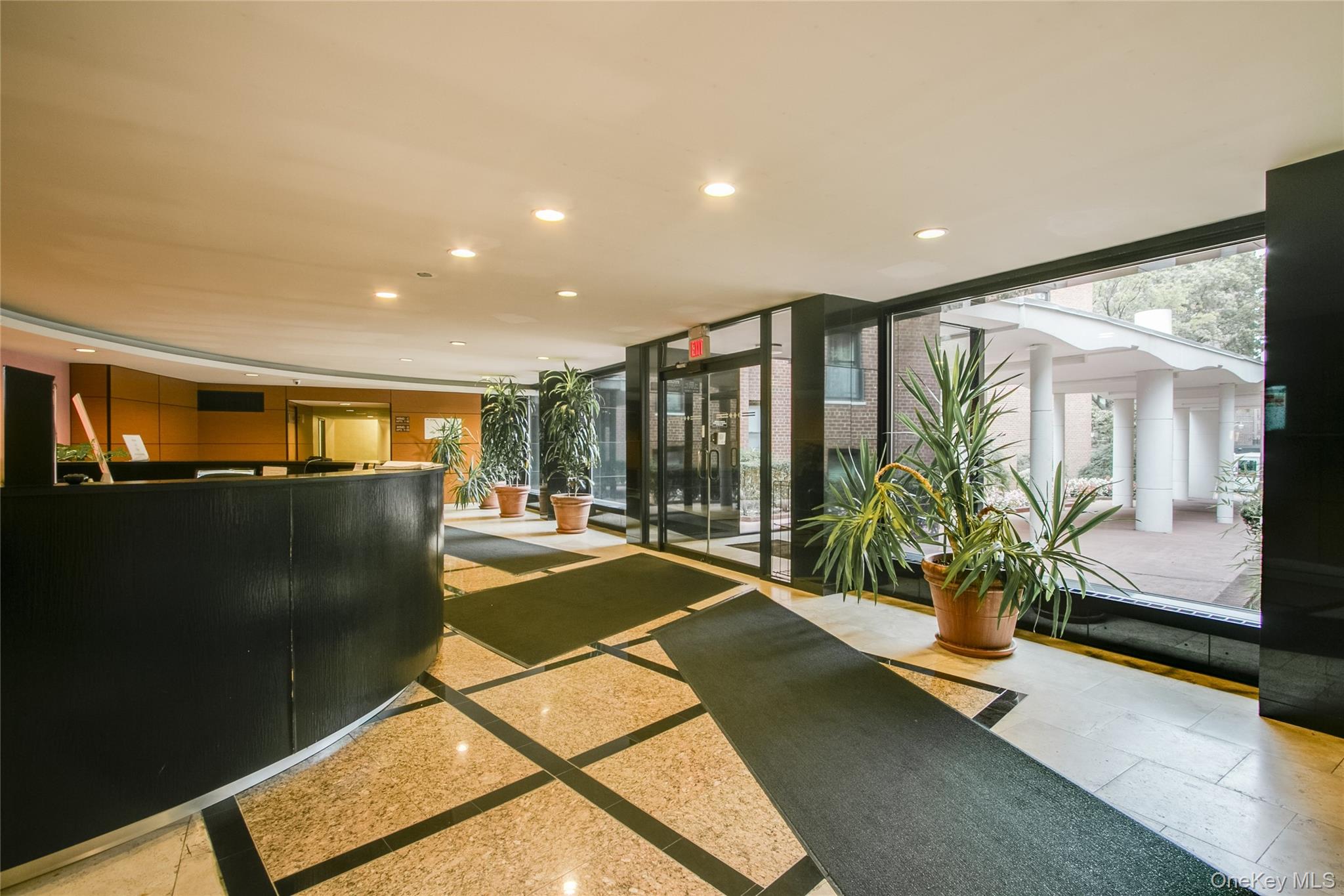 139-15 83rd Avenue, Unit 305 Queens, NY 11435 - Photo 5 of 21 a lobby with furniture and floor to ceiling window