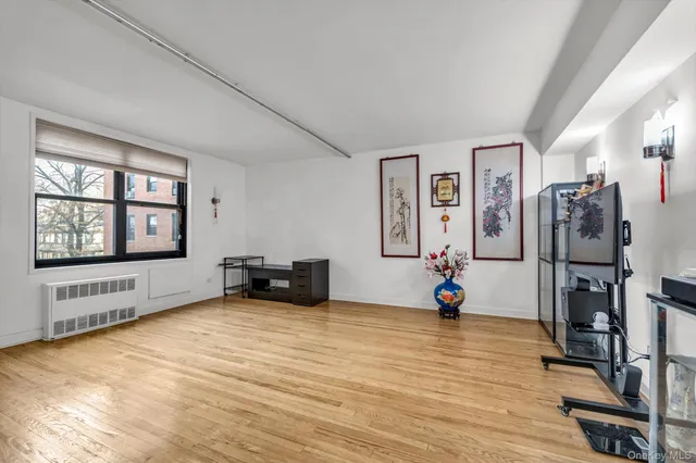 a view of a livingroom with wooden floor and furniture