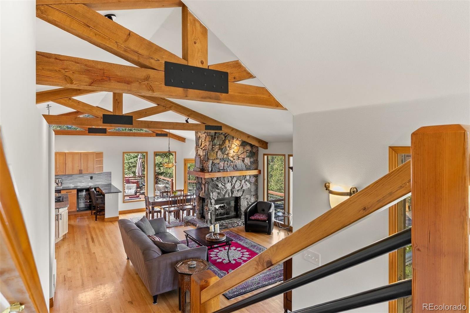 5811 Herzman Drive Evergreen, CO 80439 - Photo 20 of 49 a living room with furniture and large windows