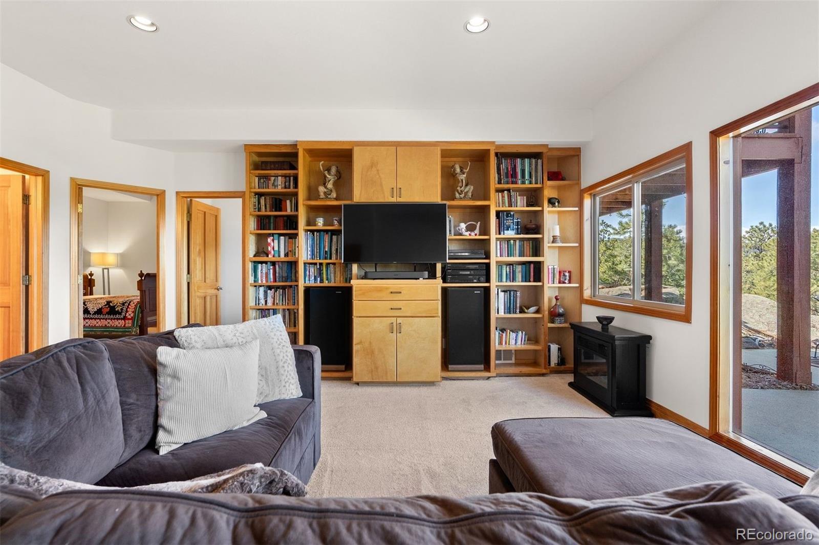 5811 Herzman Drive Evergreen, CO 80439 - Photo 29 of 49 a living room with furniture and a flat screen tv