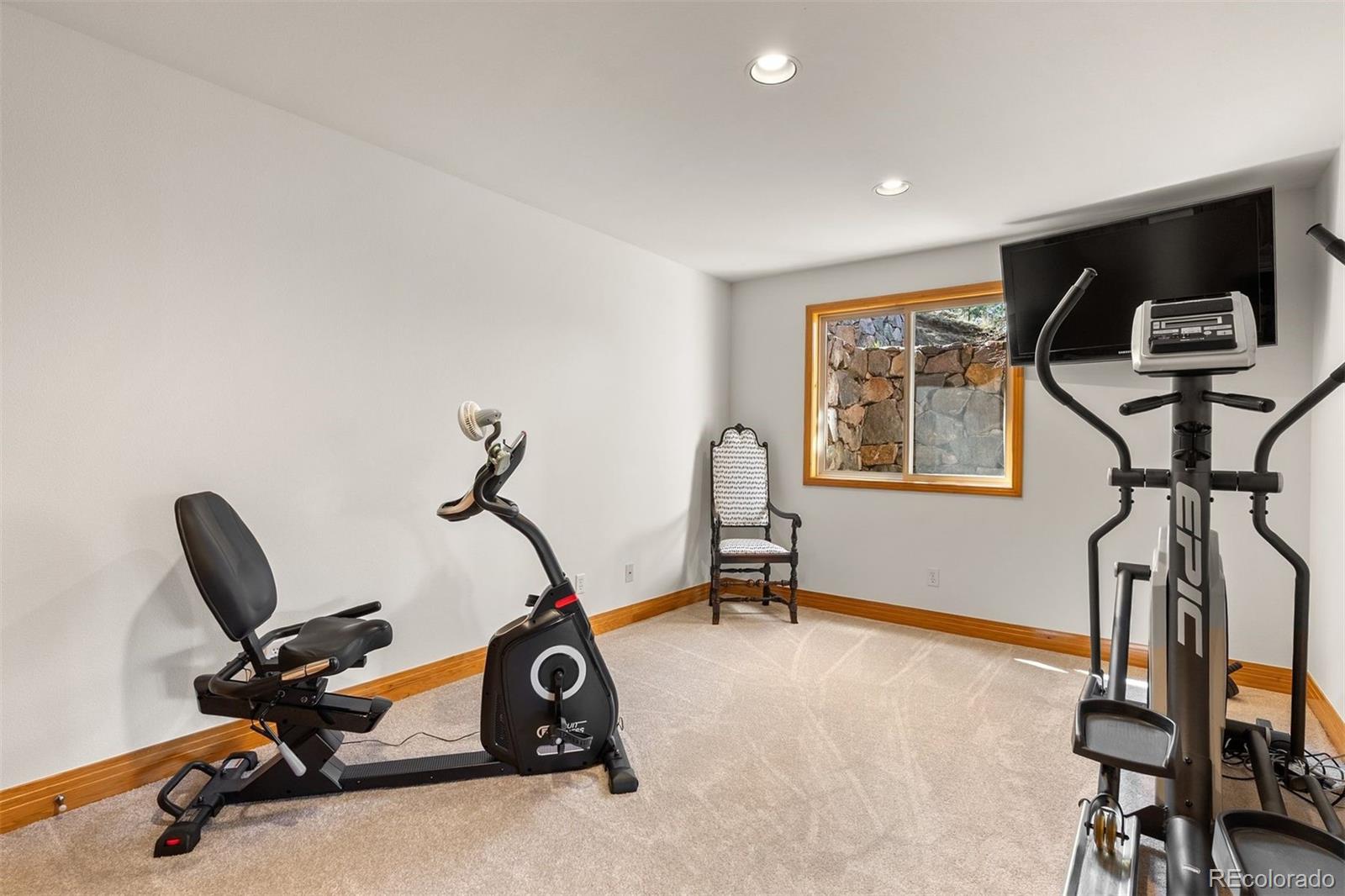 5811 Herzman Drive Evergreen, CO 80439 - Photo 34 of 49 a view of a room with gym equipment