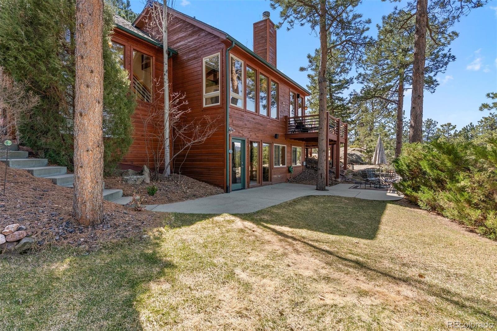 5811 Herzman Drive Evergreen, CO 80439 - Photo 35 of 49 a view of a brick building next to a yard