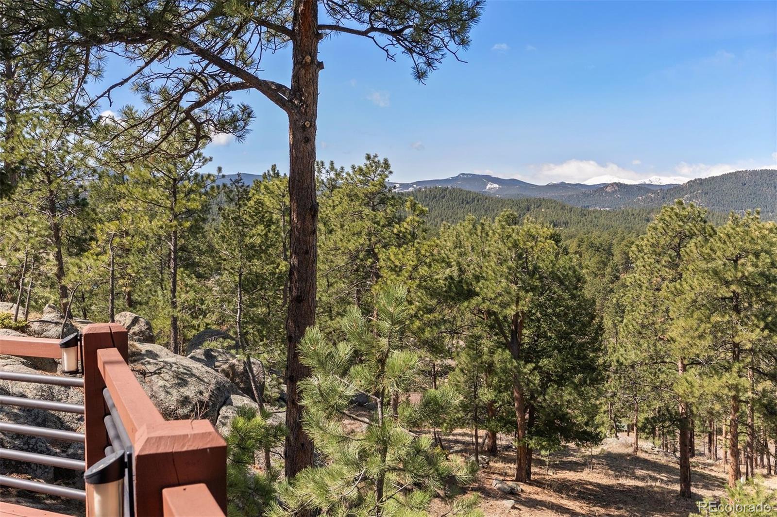5811 Herzman Drive Evergreen, CO 80439 - Photo 39 of 49 a view of a city with tall trees