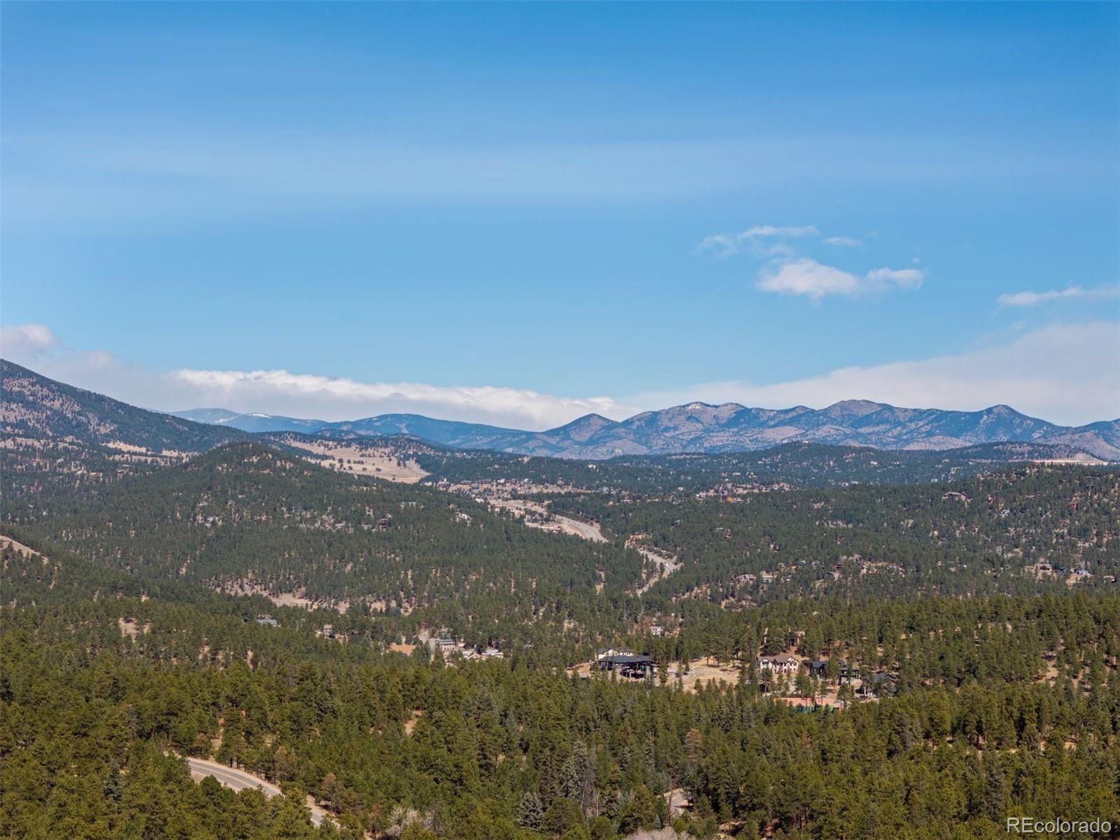 5811 Herzman Drive Evergreen, CO 80439 - Photo 49 of 49 a view of an mountain range in a cloudy sky