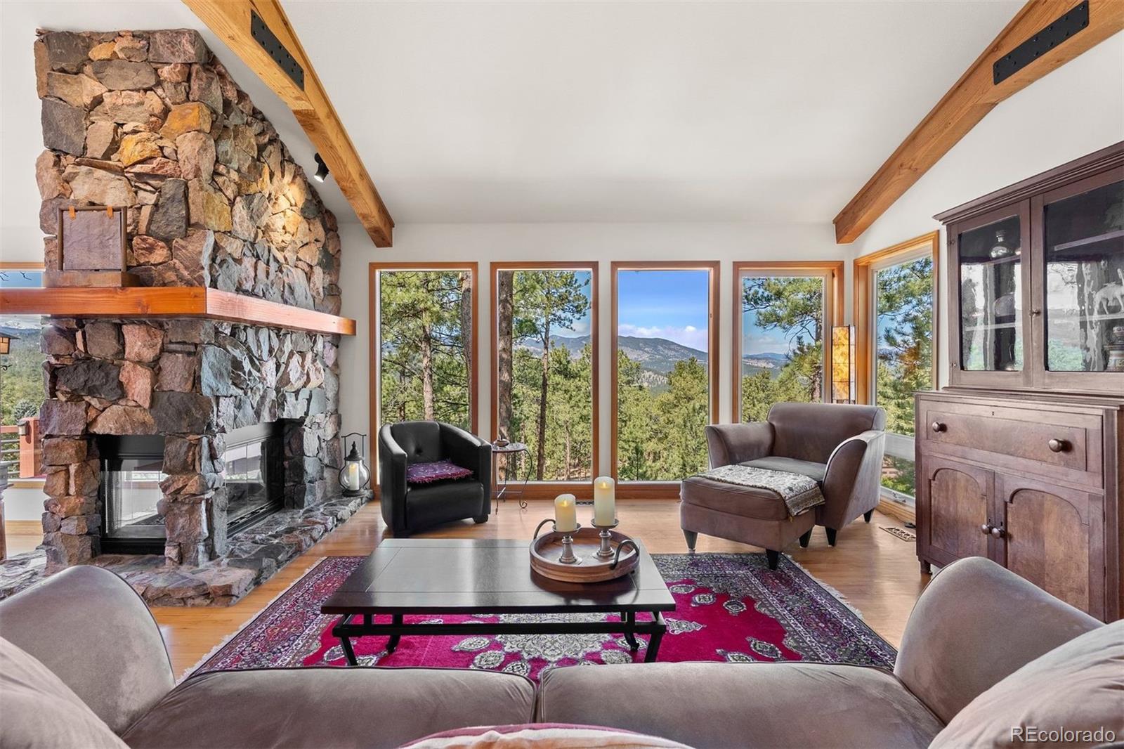 5811 Herzman Drive Evergreen, CO 80439 - Photo 7 of 49 a living room with furniture fireplace and flat screen tv
