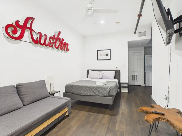 a bedroom with furniture and a wooden floor