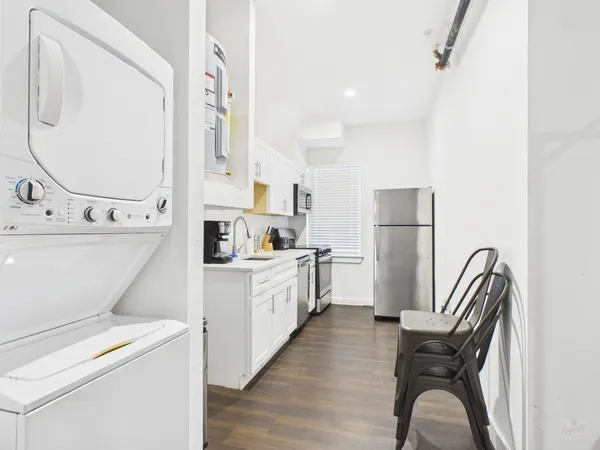 a kitchen with a refrigerator and a sink