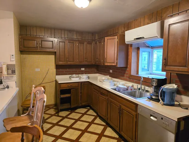 a kitchen with a sink cabinets and appliances