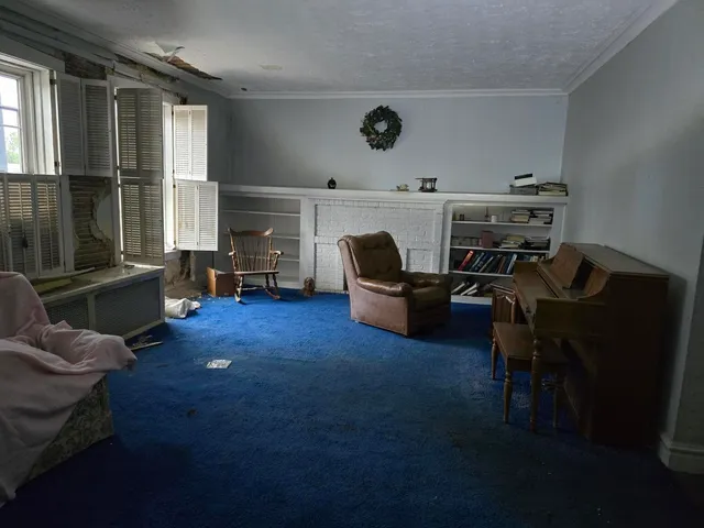 a view of livingroom with furniture and a fireplace