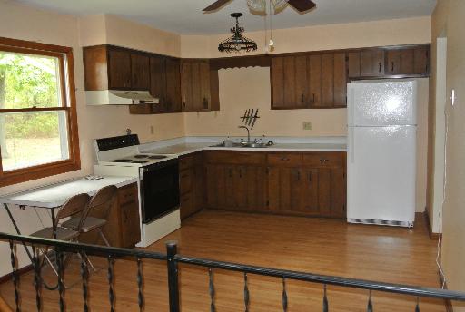 8787 Huber Road Belvidere, IL 61008 - Photo 8 of 16 a kitchen with stainless steel appliances granite countertop a sink stove and refrigerator