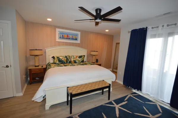 a bedroom with a bed and a large mirror
