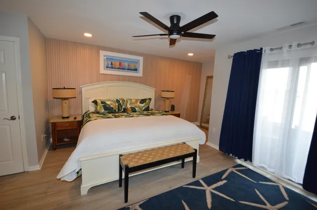 a bedroom with a bed and a large mirror