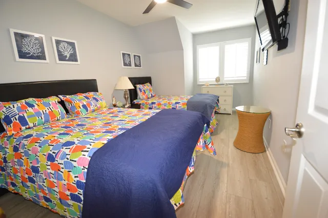 a bedroom with two beds and a chair in it