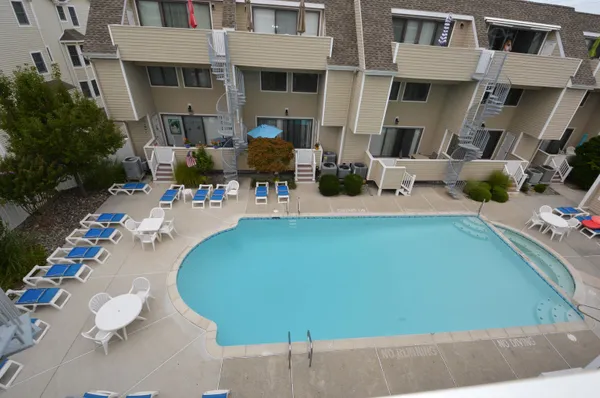 a view of a swimming pool with outdoor seating