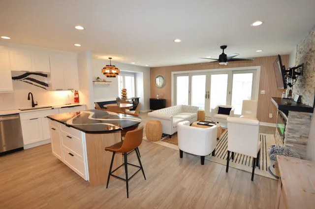 a kitchen with a dining table chairs and white cabinets