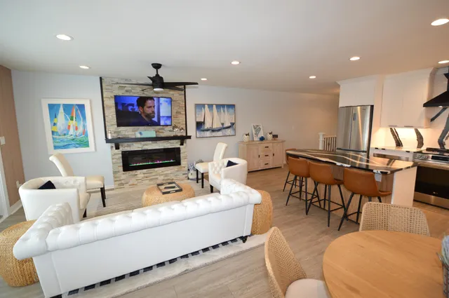 a living room with fireplace furniture and a flat screen tv