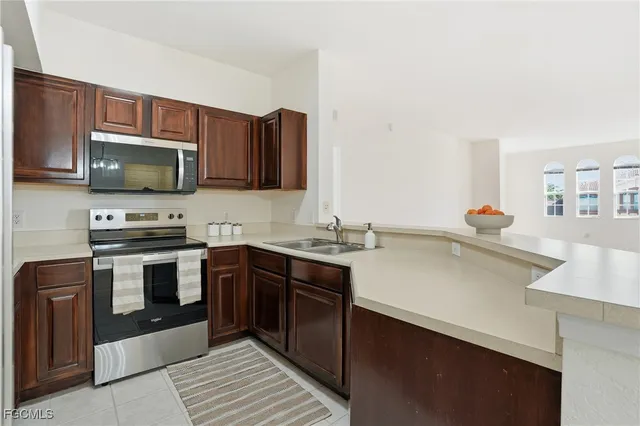 a kitchen with a sink and a refrigerator