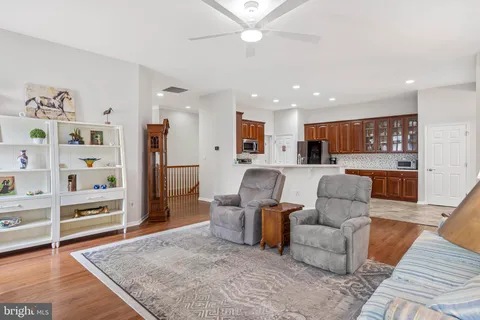 a living room with furniture and kitchen view