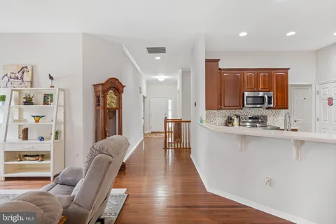 a large white kitchen with lots of counter space a sink appliances and cabinets