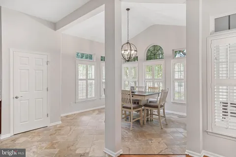 a view of a dining room with furniture and chandelier
