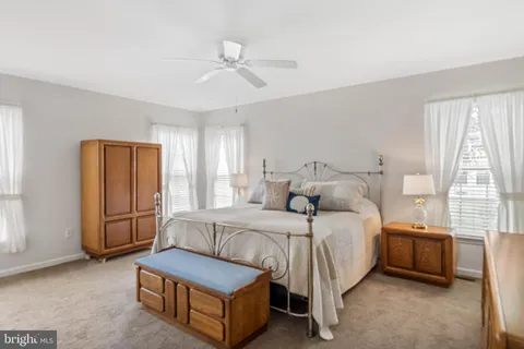 a bedroom with a bed lamp and a window