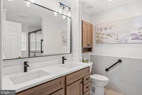 a bathroom with a sink toilet and mirror