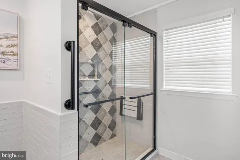 a bathroom with a shower and a window