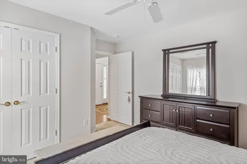 a bedroom with a bed and a mirror