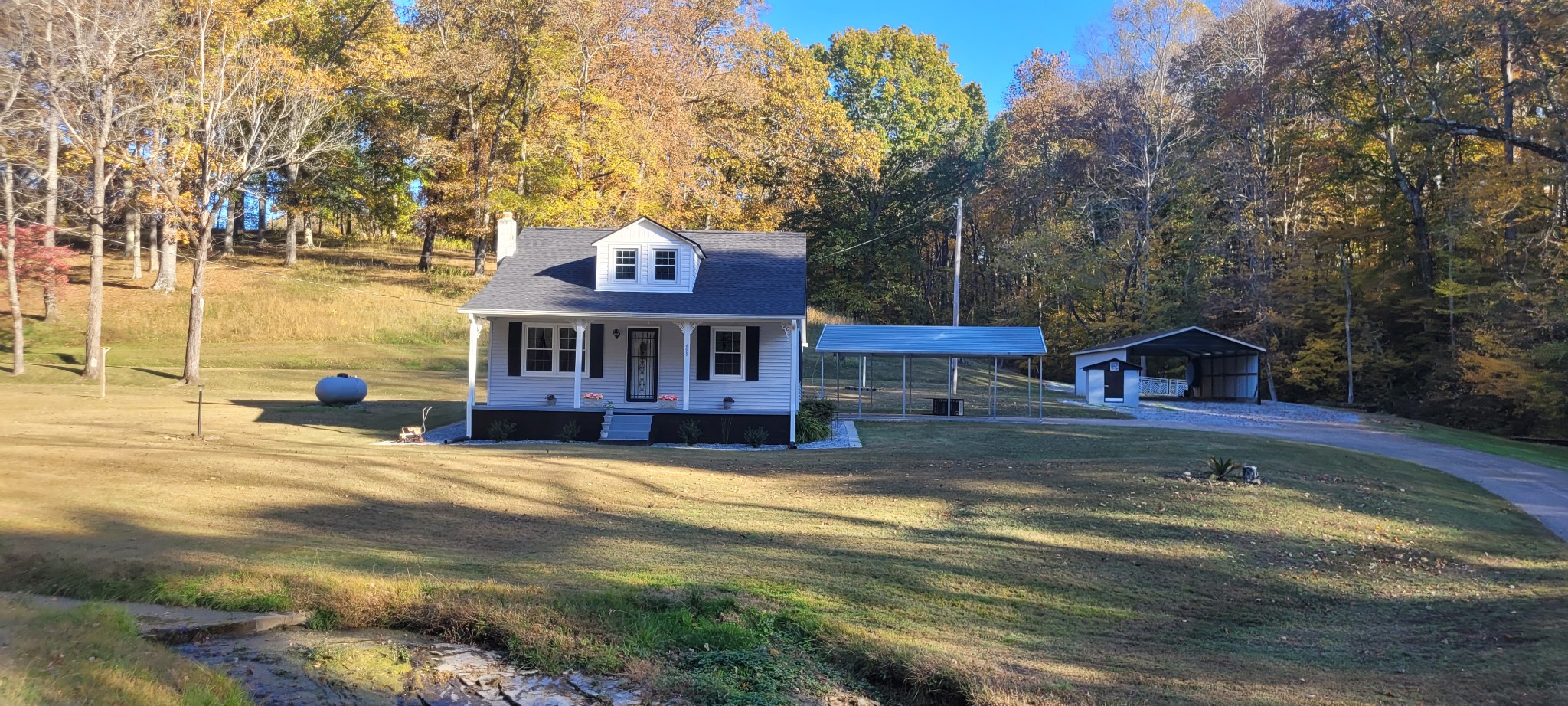 a view of a house with pool and sitting area