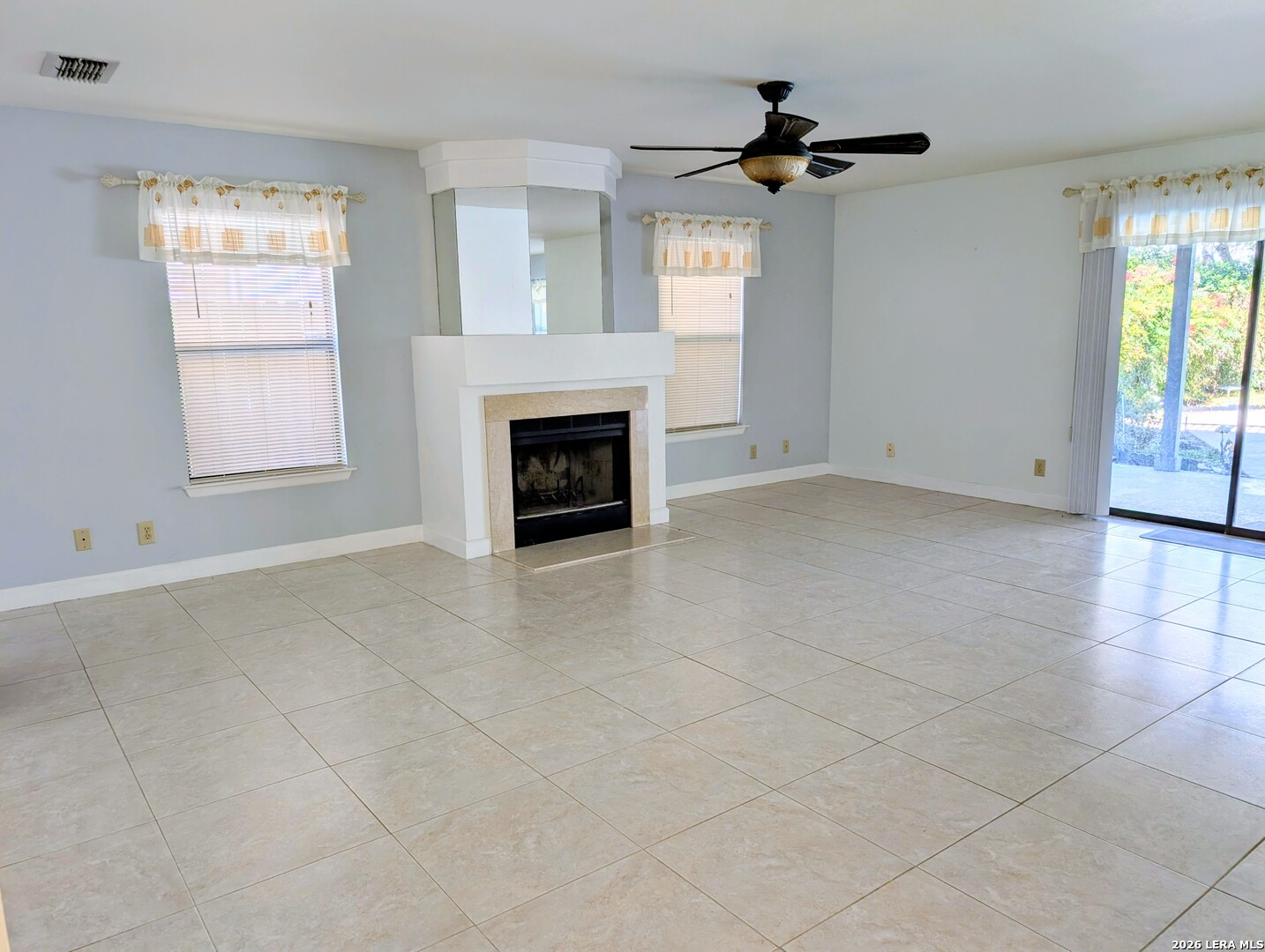 16414 Bulverde Point San Antonio, TX 78247 - Photo 11 of 46 an empty room with windows and a fireplace