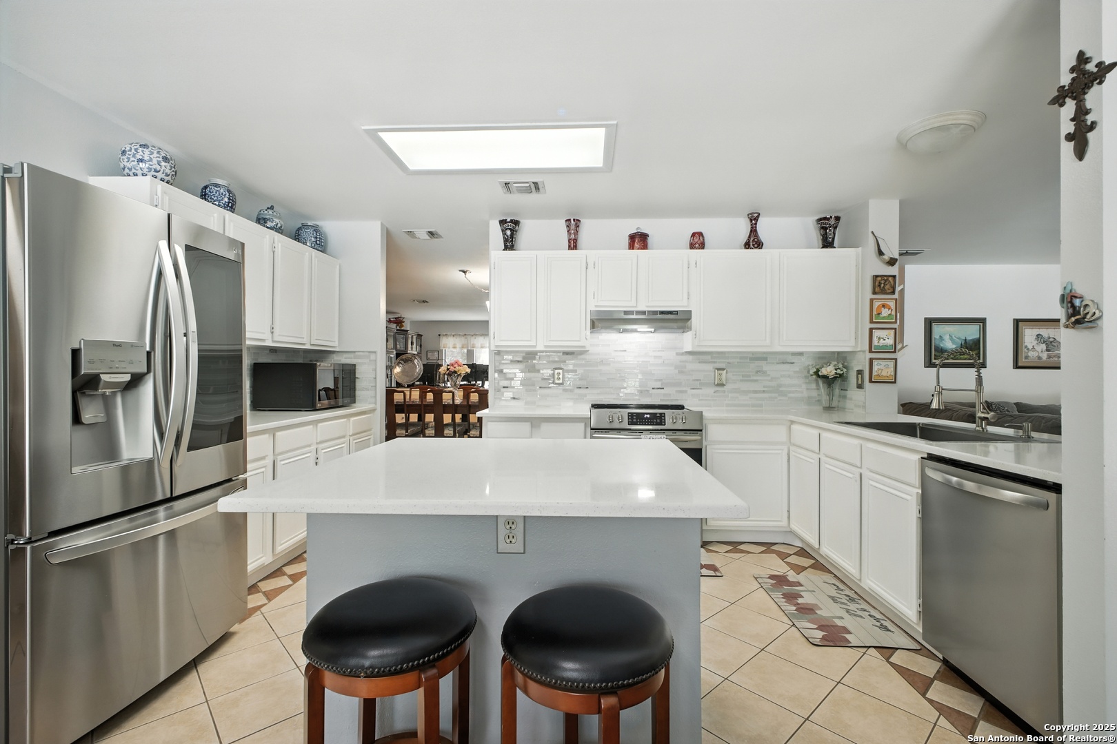 16414 Bulverde Point San Antonio, TX 78247 - Photo 14 of 46 a kitchen with stainless steel appliances a stove a sink and a refrigerator